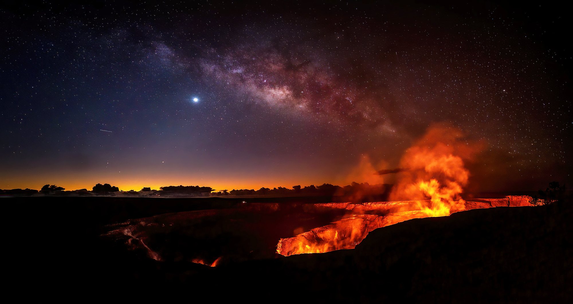 The Milky Way and Venus above the glowing lava of the Kilauea caldera at night